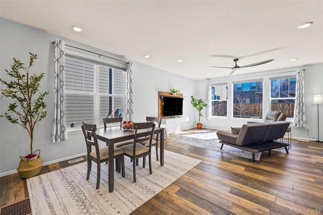 dining room with recessed lighting, baseboards, and hardwood / wood-style floors