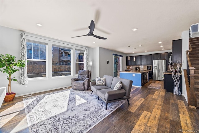 living area with ceiling fan, stairway, dark wood finished floors, and recessed lighting