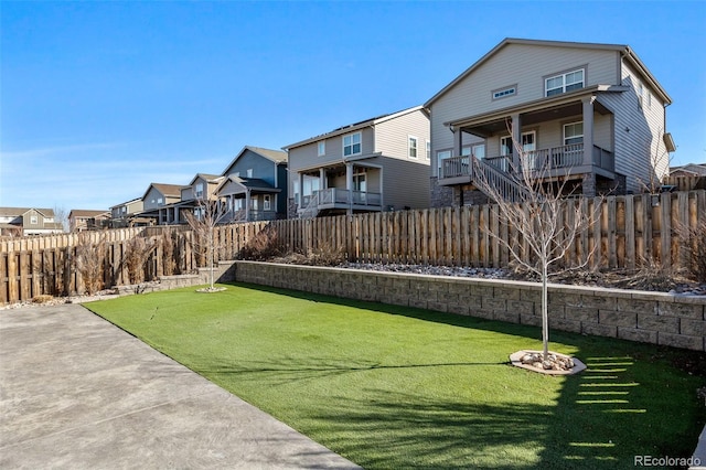 view of yard featuring a fenced backyard and a residential view