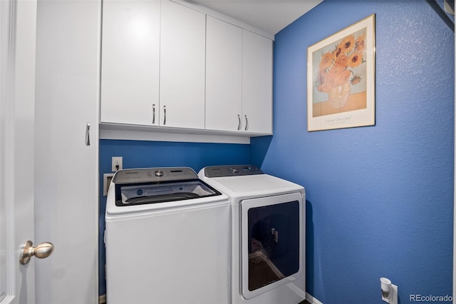 laundry room with cabinet space and washing machine and clothes dryer