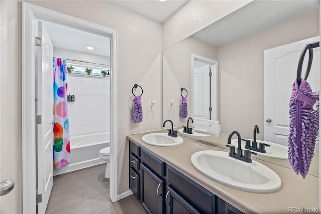 full bath with double vanity, a sink, toilet, and shower / tub combo with curtain