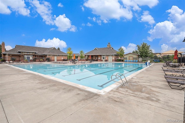 pool featuring a patio area and fence