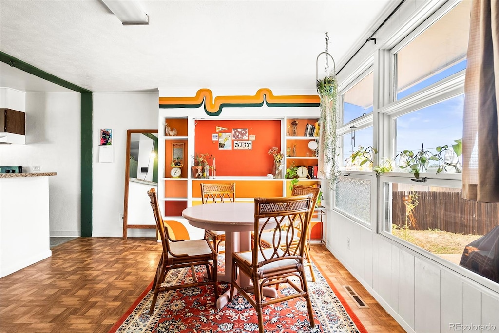 dining space featuring light parquet floors