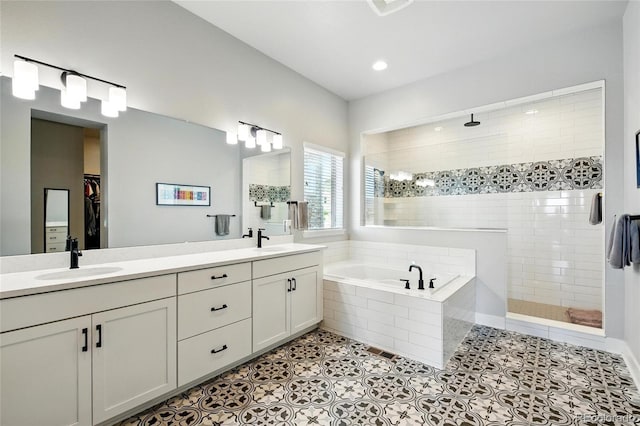 18212 W 95th Pl, Arvada, CO 80007 - bathroom with walk in shower, a bath, double vanity, tile patterned flooring, and a spacious closet