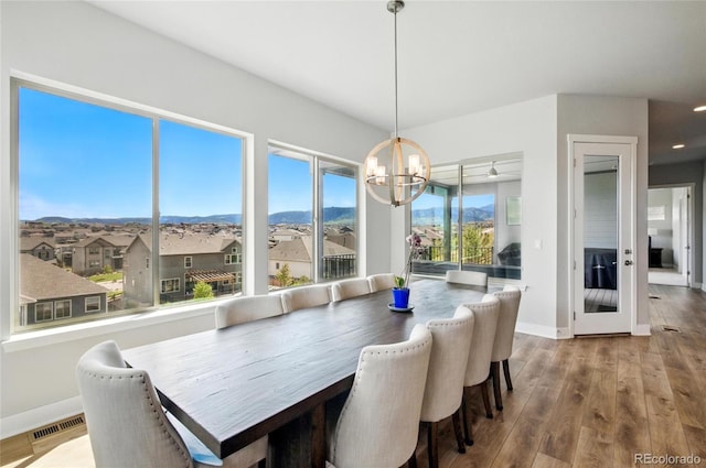 18212 W 95th Pl, Arvada, CO 80007 - dining room with a chandelier, a mountain view, wood finished floors, and baseboards