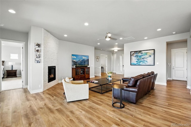 18212 W 95th Pl, Arvada, CO 80007 - living room featuring light wood-style floors, ceiling fan, recessed lighting, a fireplace, and baseboards