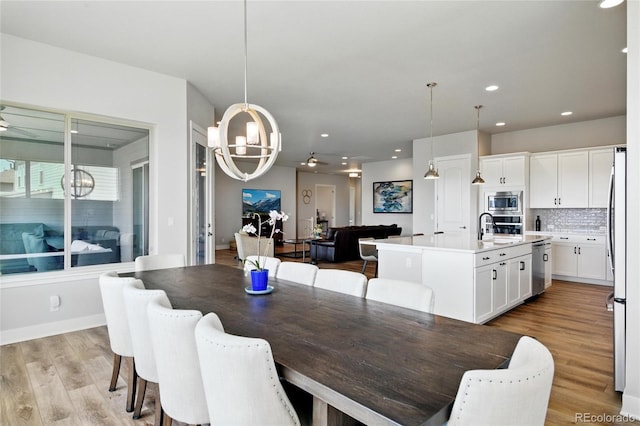 18212 W 95th Pl, Arvada, CO 80007 - dining room with light wood-type flooring, a chandelier, and recessed lighting