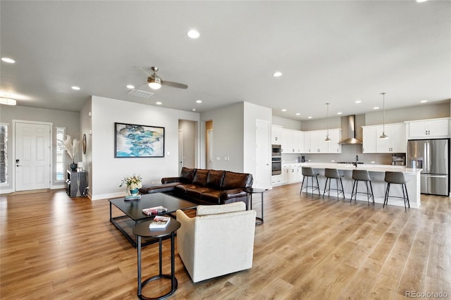 18212 W 95th Pl, Arvada, CO 80007 - living room featuring recessed lighting, light wood-style flooring, baseboards, and a ceiling fan