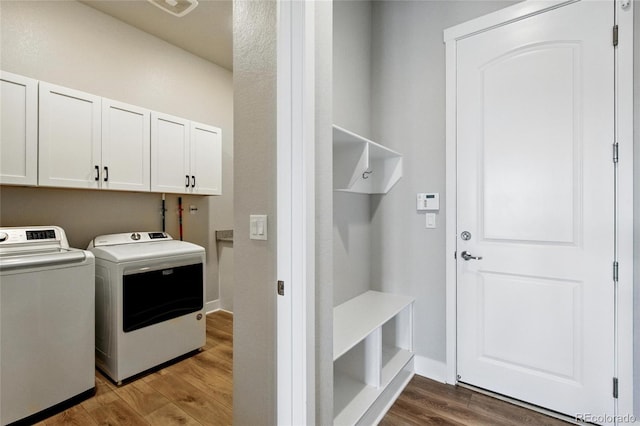 18212 W 95th Pl, Arvada, CO 80007 - laundry room featuring cabinet space, washing machine and clothes dryer, wood finished floors, and baseboards