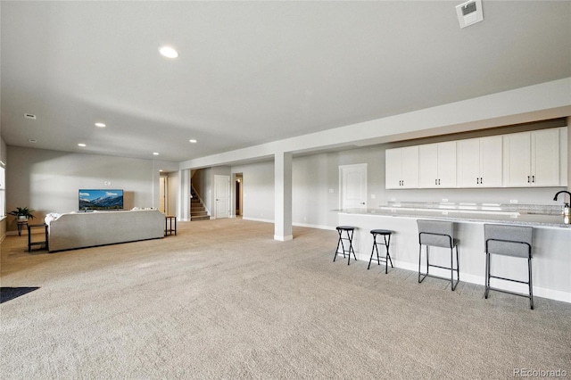 18212 W 95th Pl, Arvada, CO 80007 - living room with light carpet, recessed lighting, stairway, and baseboards
