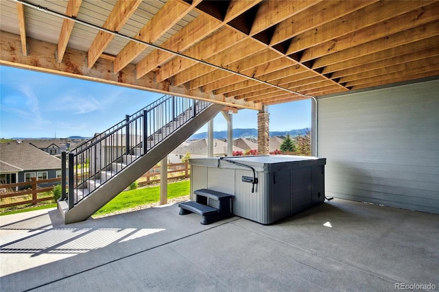 18212 W 95th Pl, Arvada, CO 80007 - view of patio / terrace with stairway, a hot tub, and a mountain view