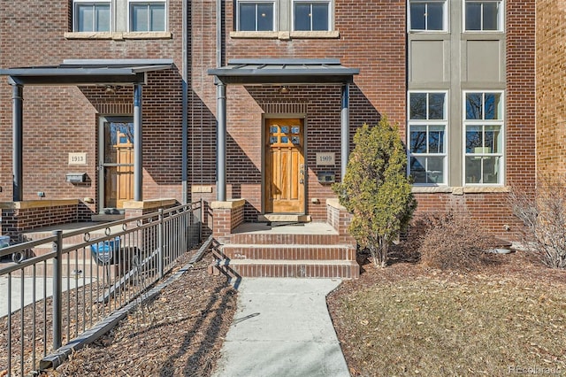 property entrance featuring brick siding