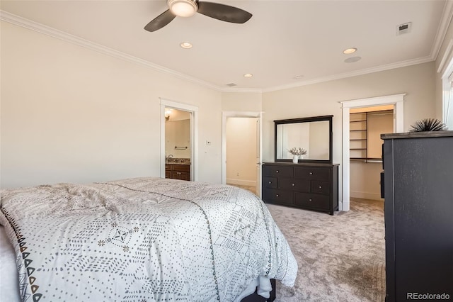 bedroom featuring carpet floors, visible vents, crown molding, and a spacious closet