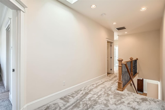 hall featuring visible vents, baseboards, an upstairs landing, carpet floors, and recessed lighting