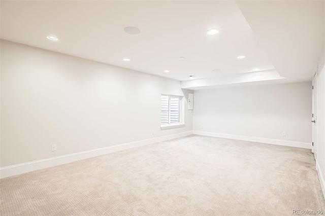 unfurnished room with baseboards, recessed lighting, and light colored carpet