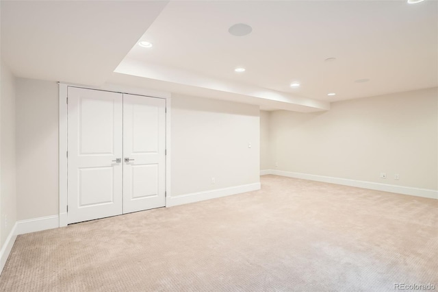 finished below grade area with recessed lighting, light carpet, and baseboards