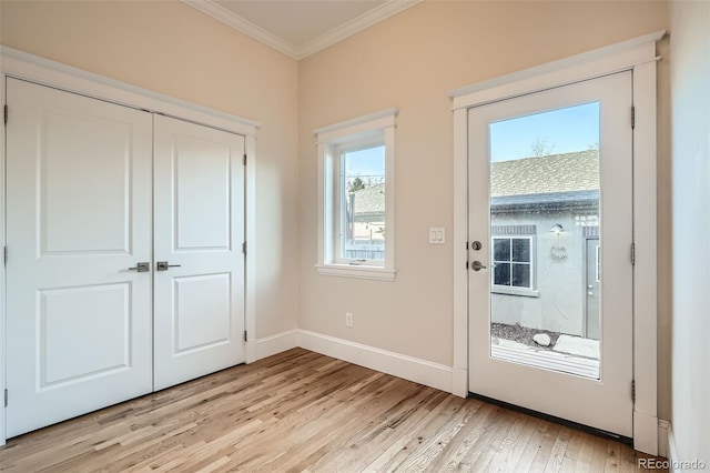 doorway with baseboards, light wood-type flooring, and crown molding