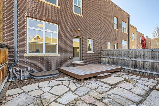 view of patio / terrace featuring fence and a deck