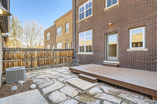 view of patio featuring cooling unit and fence