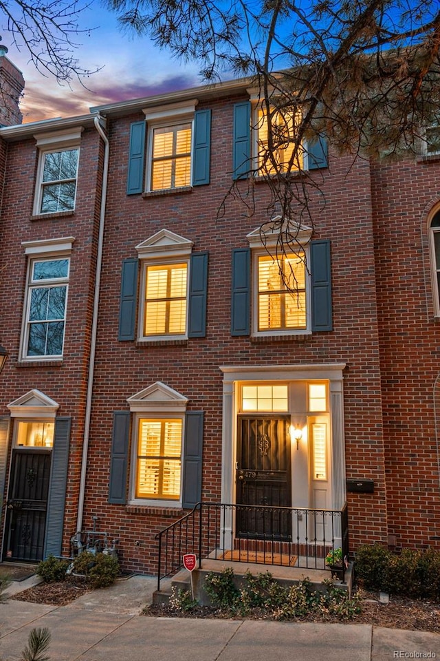 view of property featuring brick siding