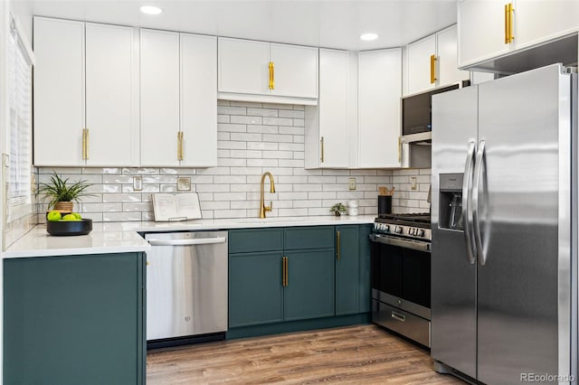 kitchen featuring dark wood finished floors, white cabinetry, stainless steel appliances, and light countertops