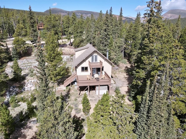 birds eye view of property featuring a mountain view and a forest view