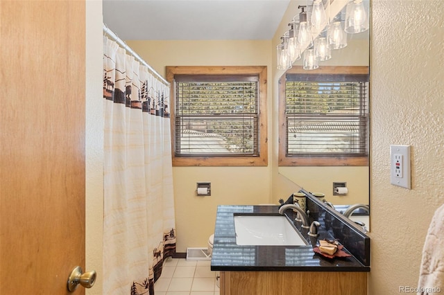 bathroom with a shower with curtain, tile patterned flooring, baseboards, and vanity