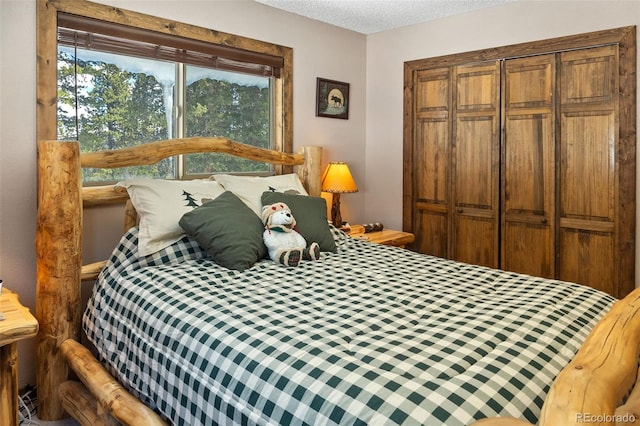 bedroom featuring a closet, multiple windows, and a textured ceiling