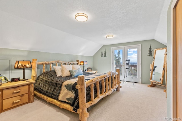 bedroom featuring access to exterior, light carpet, vaulted ceiling, and a textured ceiling