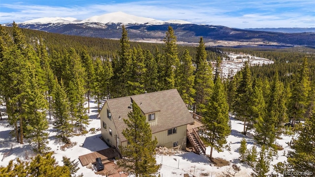 aerial view featuring a forest view and a mountain view