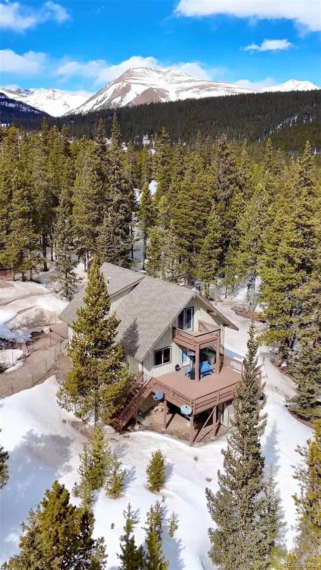 birds eye view of property with a mountain view and a forest view