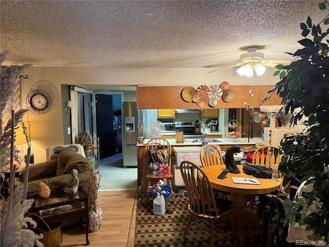 9410 W 89th Cir, Broomfield, CO 80021 - dining room featuring a textured ceiling, ceiling fan, and light wood-type flooring