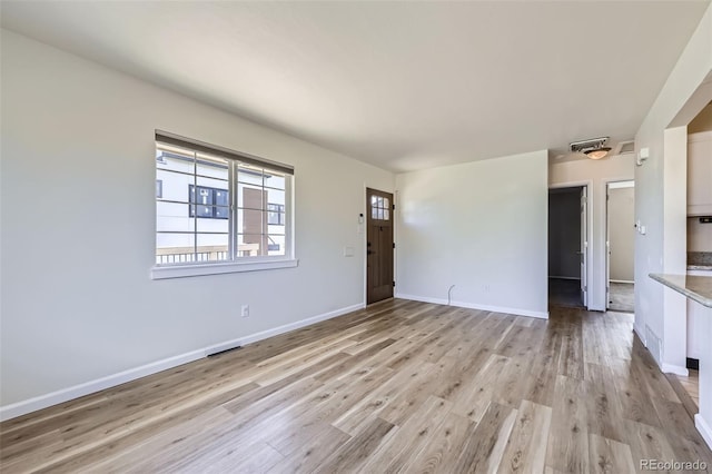 951 Tennyson St, Denver, CO 80204 - unfurnished living room featuring light wood-style flooring, baseboards, and visible vents