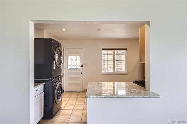 951 Tennyson St, Denver, CO 80204 - washroom with stacked washer and clothes dryer, light tile patterned flooring, and recessed lighting