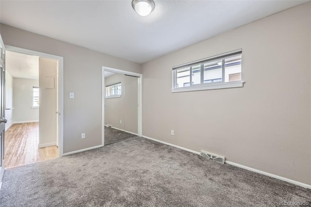 951 Tennyson St, Denver, CO 80204 - unfurnished bedroom with baseboards, carpet flooring, a closet, and visible vents