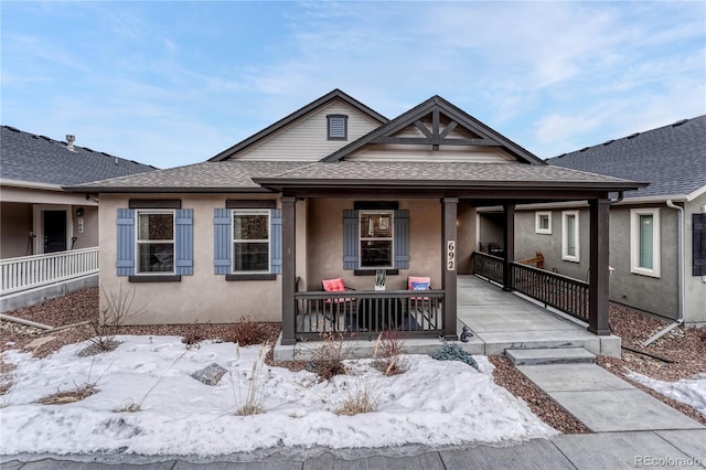 692 Sage Forest Ln, Monument, CO 80132 - bungalow with a shingled roof, covered porch, and stucco siding
