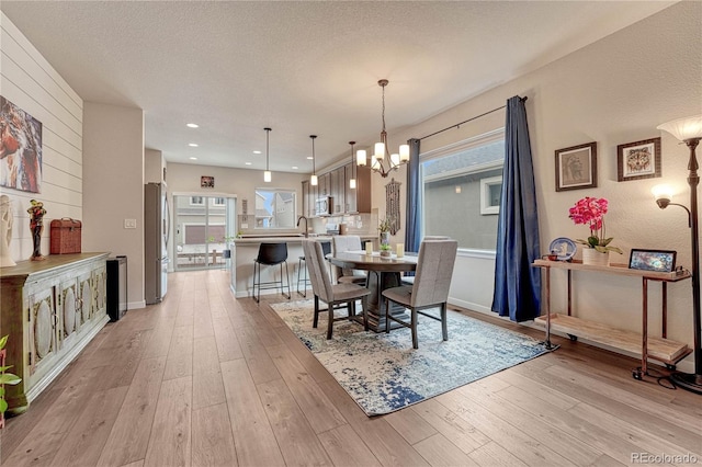 692 Sage Forest Ln, Monument, CO 80132 - dining area featuring a chandelier, light wood-type flooring, recessed lighting, and baseboards