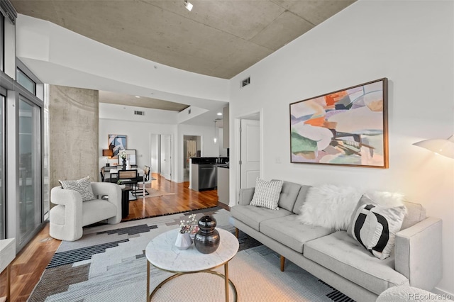 living room featuring visible vents and wood finished floors