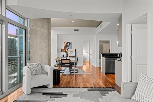 living area with visible vents and light wood-style flooring