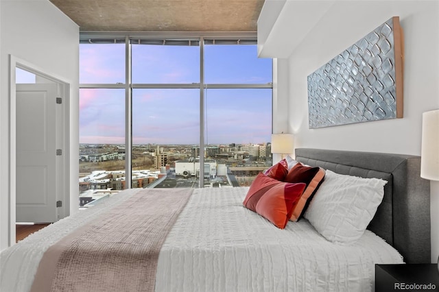 bedroom with a city view and floor to ceiling windows