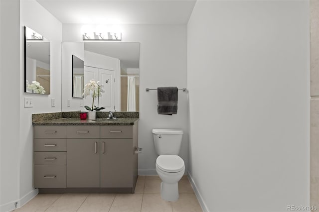 full bath with baseboards, toilet, vanity, and tile patterned flooring