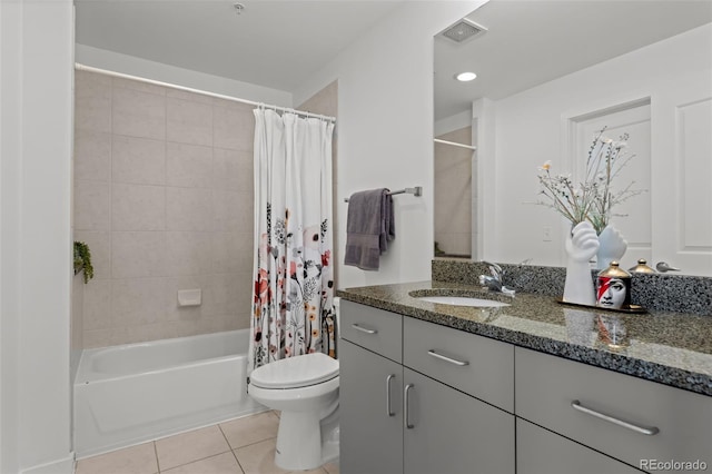 bathroom with visible vents, toilet, tile patterned floors, shower / bath combination with curtain, and vanity