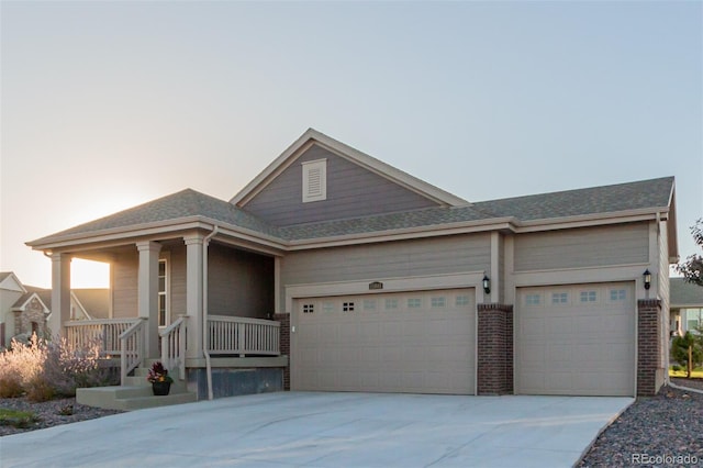 view of front of house featuring a porch and a garage