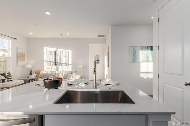 kitchen with sink and light stone counters