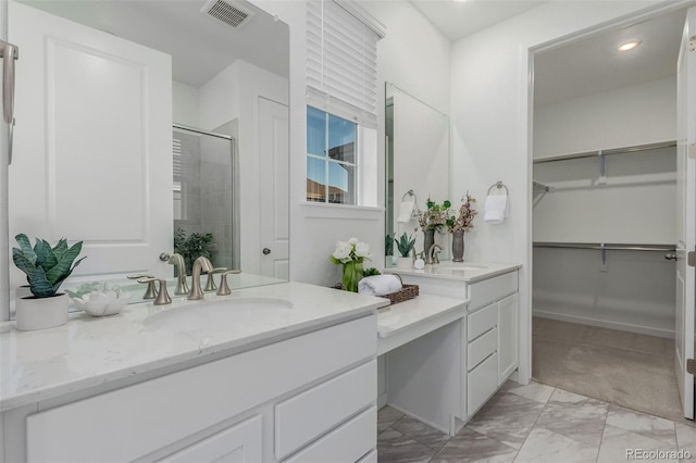 bathroom with vanity and a shower with shower door