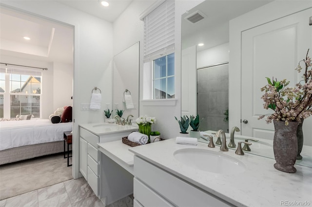 bathroom with vanity and a tile shower