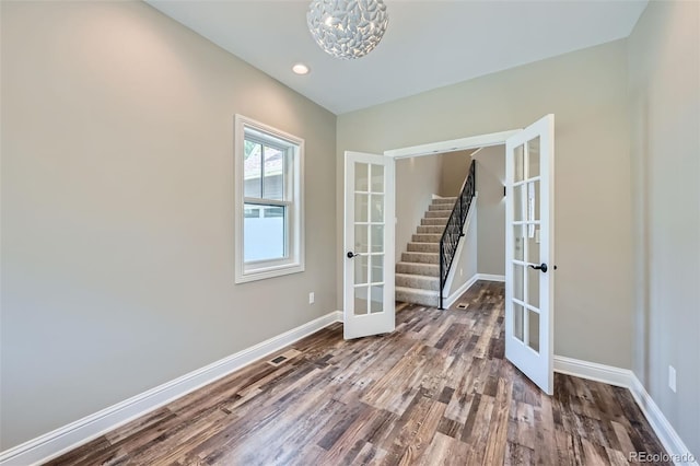 unfurnished room featuring wood-type flooring and french doors