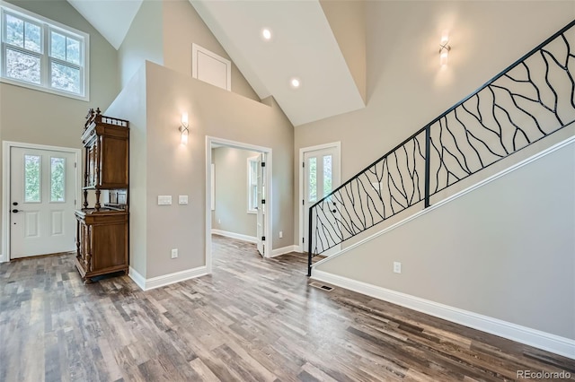 entrance foyer featuring high vaulted ceiling, a wealth of natural light, and wood-type flooring