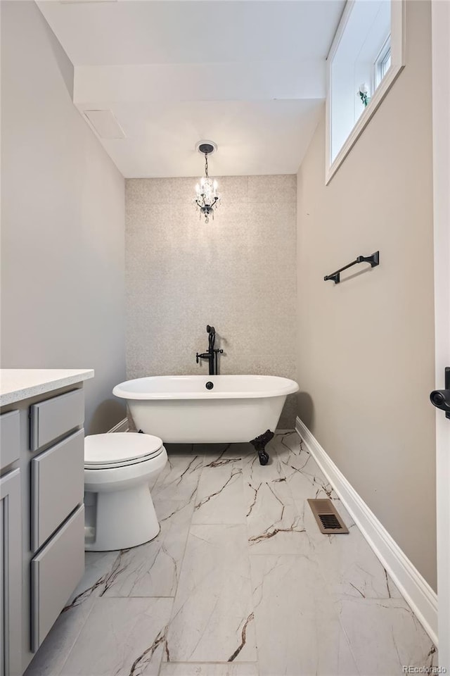 bathroom featuring vanity, toilet, and a bathing tub