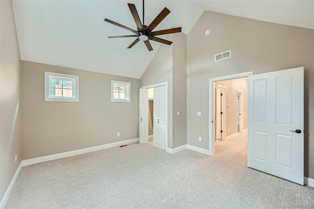 unfurnished bedroom with ceiling fan, light carpet, and high vaulted ceiling